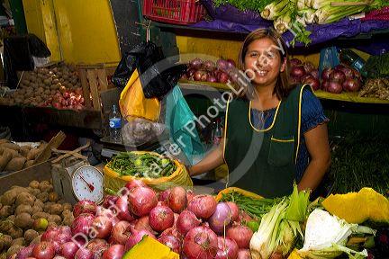 Vendor at a cooperative produce market in the Chorrillos district of Lima, Peru.