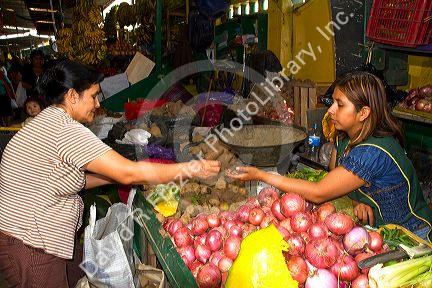 Vendor at a cooperative produce market in the Chorrillos district of Lima, Peru.
