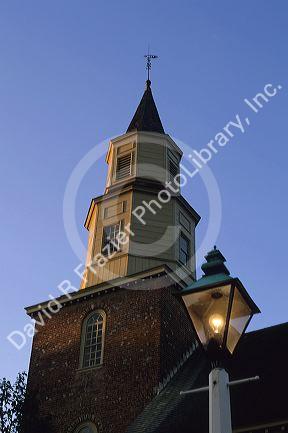 Lamp post in front of Bruton Parish Church in colonial Williamsburg, Virginia at dusk.