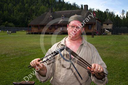 Blacksmith participate in a rendezvous re-enactment at the Grand Portage National Monument on the north shore of Lake Superior in northeastern Minnesota, USA.