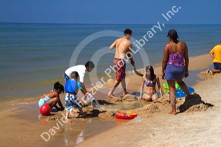 People on the beach at Little Sable Point Light on Lake Michigan in Golden Township, Michigan, USA.