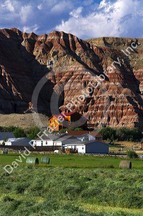 Red rock cliffs and newly harvested alfalfa hay near Dubois, Wyoming, USA.
