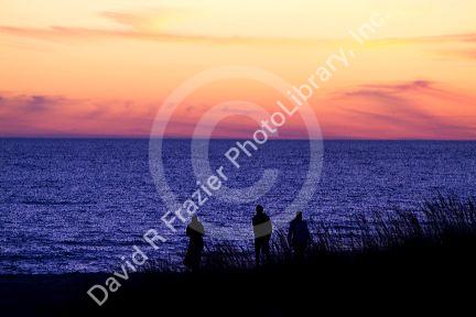 People watch the sunset on Lake Michigan at Pere Marquette Harbor located in Ludington, Michigan, USA.
