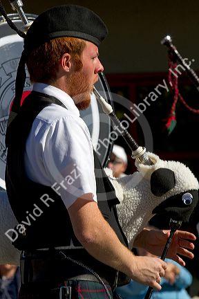 The Boise Highlanders playing bagpipes and drums in the Trailing of the Sheep Parade on Main Street in Ketchum, Idaho, USA.