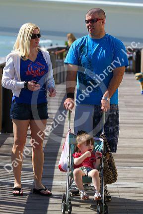Family on the boardwalk at Johns Pass Village located on the waterfront at Madeira Beach, Florida, USA.
