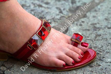 Woman wearing a red jeweled sandal at the Temple of the Emerald Buddha located within the precincts of the Grand Palace, Bangkok, Thailand.