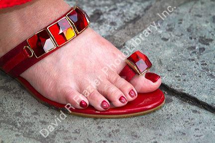 Woman wearing a red jeweled sandal at the Temple of the Emerald Buddha located within the precincts of the Grand Palace, Bangkok, Thailand.