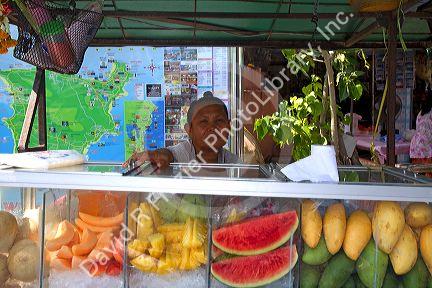 Street food vendors selling fruit at Chaweng beach village on the island of Ko Samui, Thailand.