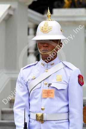Guard wearing a white uniform at The Grand Palace in Bangkok, Thailand.