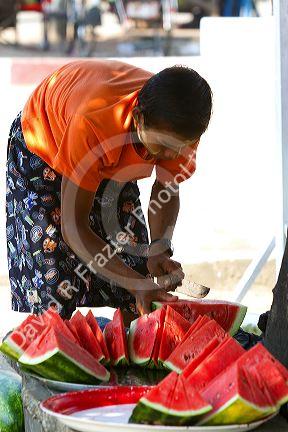 Street vendor selling sliced watermelon in (Rangoon) Yangon, (Burma) Myanmar.