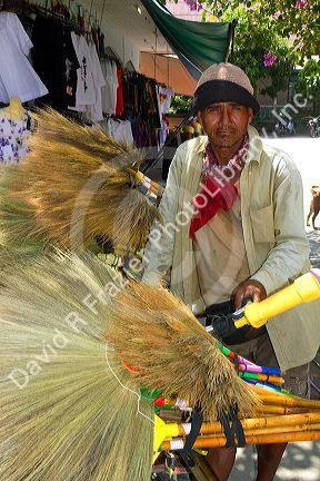 Street vendors selling dried grass brooms on the island of Ko Samui, Thailand.