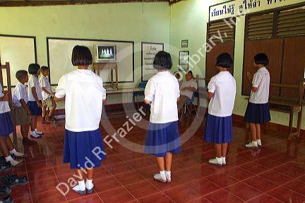 Thai elementary students dance with direction from a television at school on the island of Ko Samui, Thailand.