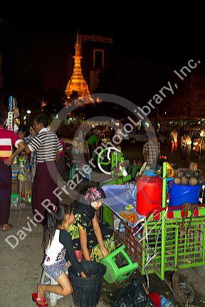 Street vendors sell goods near the Sule Paya located in the heart of downtown (Rangoon) Yangon, (Burma) Myanmar.