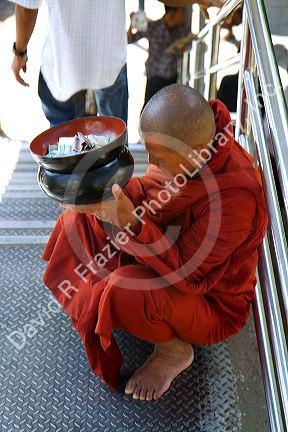 Buddhist monk with alms bowl in (Rangoon) Yangon, (Burma) Myanmar.