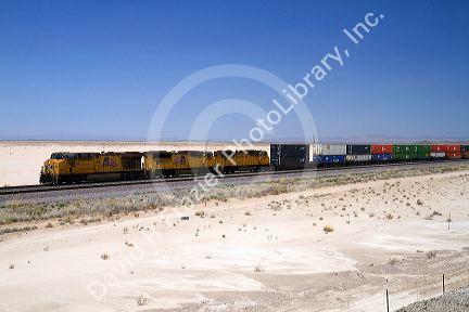 Union Pacific Railroad locomotive traveling along Interstate 10 through southwest New Mexico, USA.