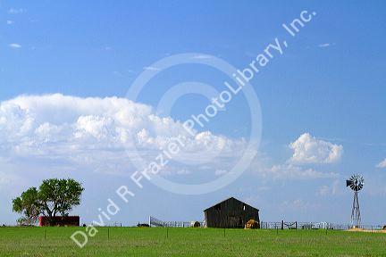 Barn and windmill on farmland near Dalhart, Texas, USA.