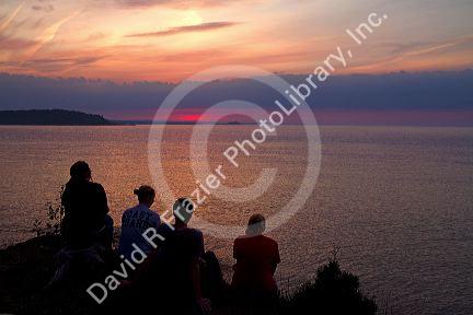People watch the sunset on Lake Superior at Marquette, Michigan, USA.