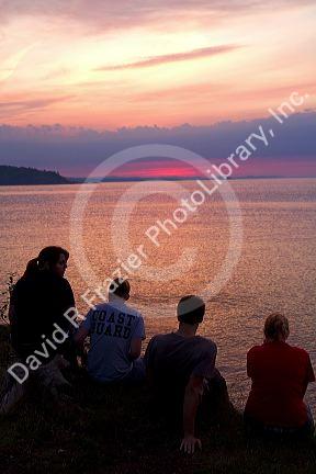 People watch the sunset on Lake Superior at Marquette, Michigan, USA.