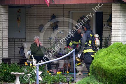Firefighters assist a resident during a house fire in Boise, Idaho, USA.