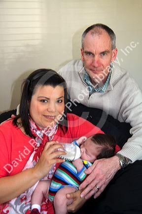 Caucasian father and hispanic mother with their infant son in Boise, Idaho, USA. MR