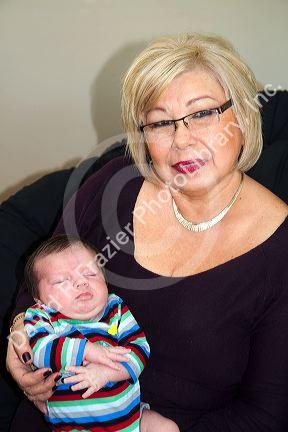 Hispanic mother holding her infant grandson in Boise, Idaho, USA.