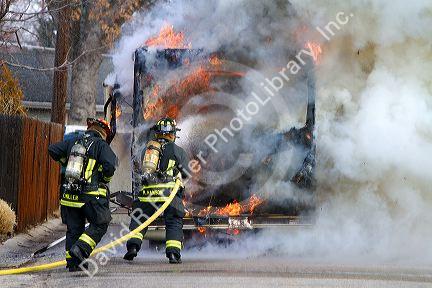 Firefighers putting out a motor home on fire in Boise, Idaho, USA.