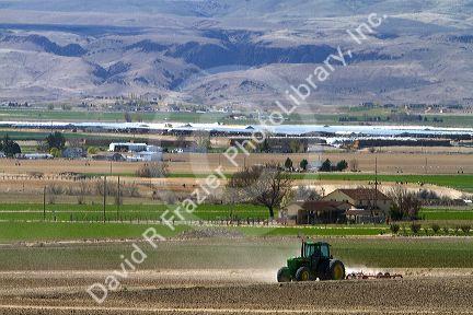 Tractor being used for spring tilling in Canyon County, Idaho, USA
