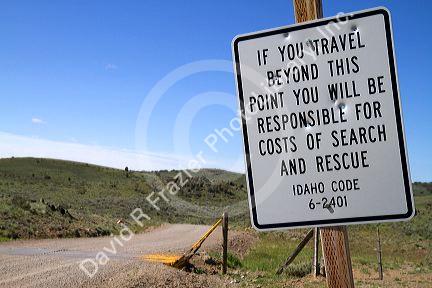 Road sign warning of search and rescue costs for traveling on unimproved road in Owyhee County, Idaho, USA.