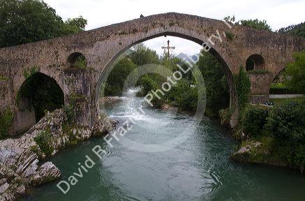 Arched Roman Bridge spanning the Sella River in the municipality of Cangas de Onis in Asturias, Spain.