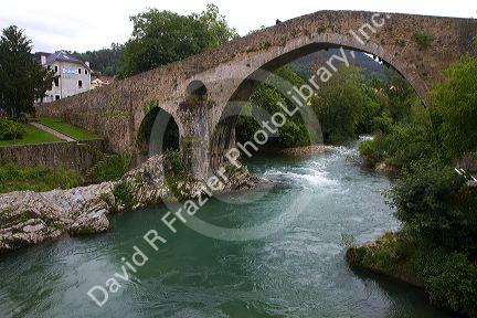 Arched Roman Bridge spanning the Sella River in the municipality of Cangas de Onis in Asturias, Spain.
