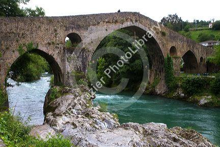 Arched Roman Bridge spanning the Sella River in the municipality of Cangas de Onis in Asturias, Spain.
