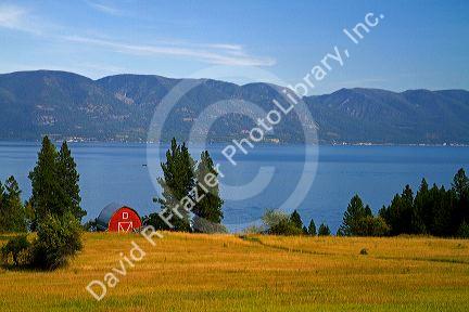 Red barn and farmland along Flathead Lake, Montana, USA.