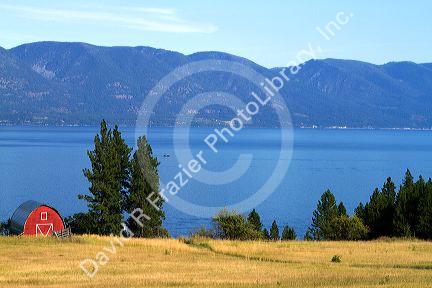 Red barn and farmland along Flathead Lake, Montana, USA.
