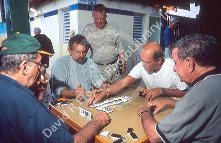 Cuban men playing dominos at Gomez Park in Little Havana, Miami, Florida.