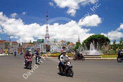 People riding scooters on the street in Da Lat, Vietnam.