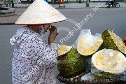 Vietnamese street vendor selling durian fruit in Hanoi, Vietnam.