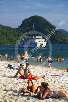 Tourists sunbathe on the beach in Ha Long Bay, Vietnam.