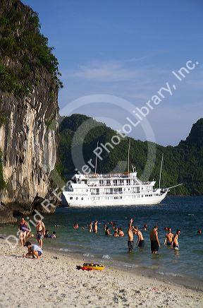 Tourists sunbathe on the beach in Ha Long Bay, Vietnam.