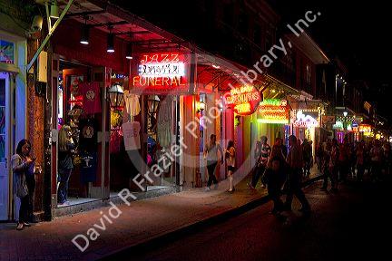 Business on Bourbon Street at night in the French Quarter, New Orleans, Louisiana, USA.