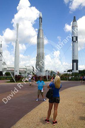 Tourists taking photos in the rocket garden at John F. Kennedy Space Center, Merritt Island, Florida, USA.
