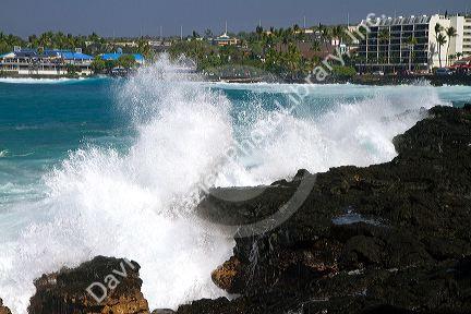 Waves crash along the rocky coast at Kailua-Kona on the Big Island of Hawaii, USA.