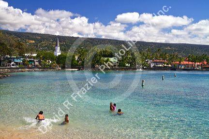 People swimming in the bay at Kailua-Kona on the Big Island of Hawaii, Hawaii, USA.