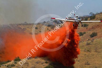 Single engine air tanker (SEAT) dropping fire retardant on a wildfire in Idaho, USA.