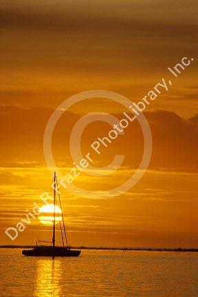 A sailboat at sunset in Tahiti.