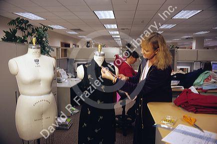 Clothing designer with garment on a dress form.