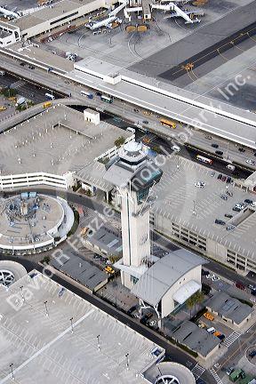 Aerial image of airplanes and traffic control tower at LAX airport, Los Angeles, California.
