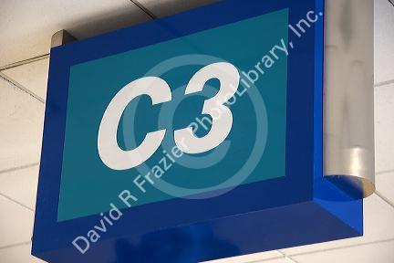 An airport boarding gate sign.