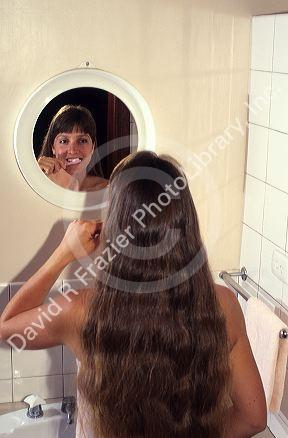 Young woman brushing her teeth.  MR