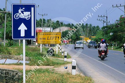 Road signs and traffic on Phuket Island in Thailand.