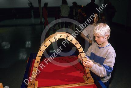 A child plays with cantenary arch made of blocks at the Science Discovery Center in Boise, Idaho.